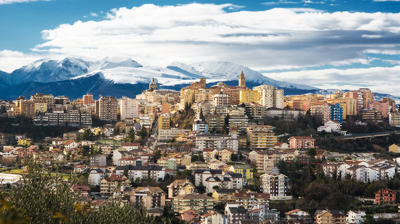 Italian village surrounded by snow peaked mountains
