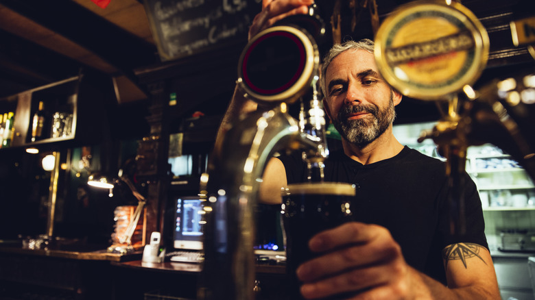 bartender pulling a pint in Irish pub