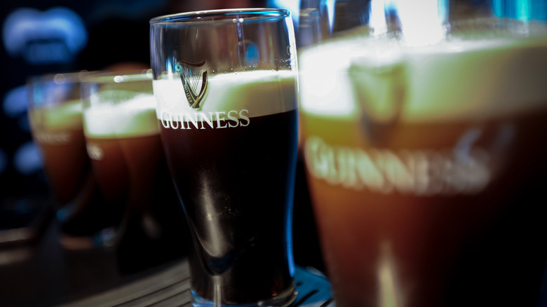 pints of Guinness nearly ready to be served