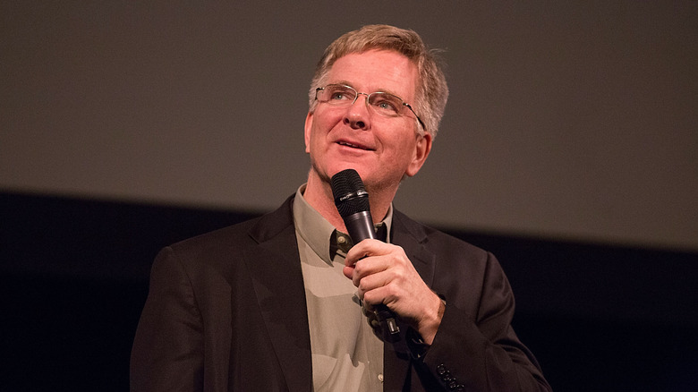 Rick Steves holding microphone 