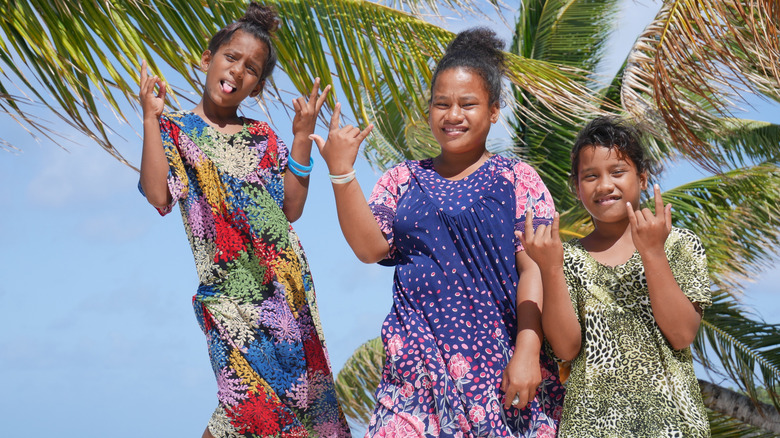 Local islanders make hand gestures on the Marshall Islands.