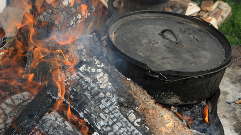 cast iron pot in campfire