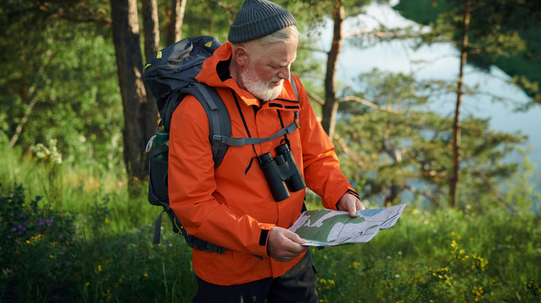 older adult using map