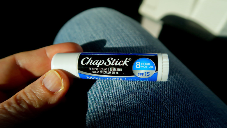 Person holding a chapstick tube 