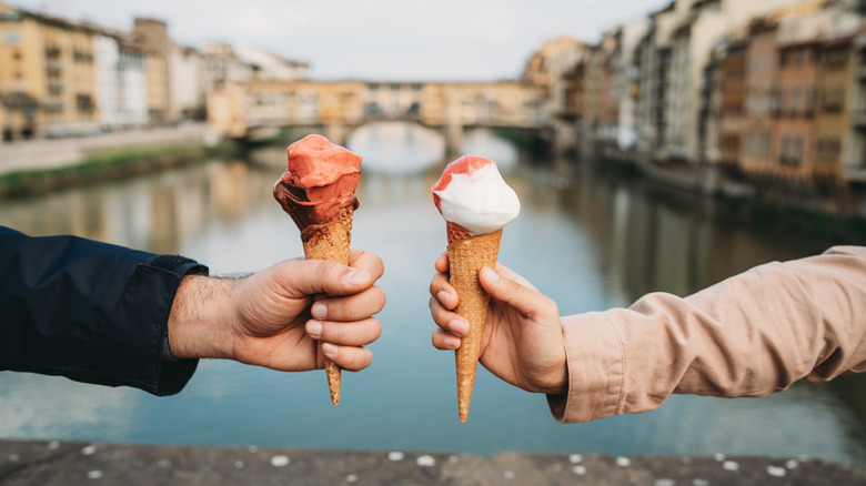 Hands holding cones of gelato in Florence
