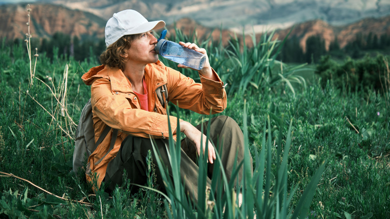 Hiker drinking from water bottle