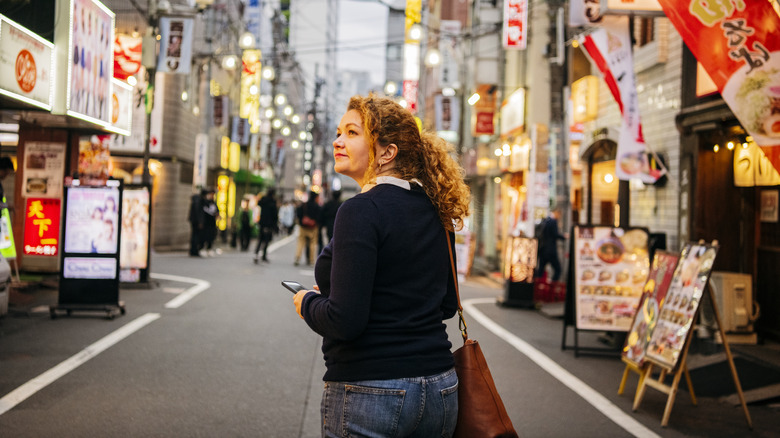 Traveler walking along Japanese alley