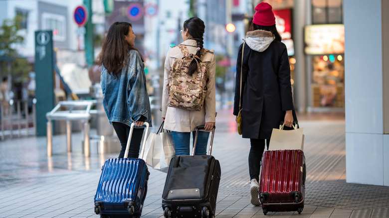 women with suitcases in Japan