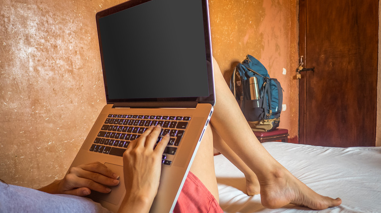 digital nomad working in bed