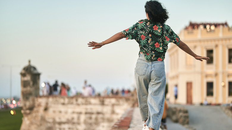 back view of a person seen walking on a bridge