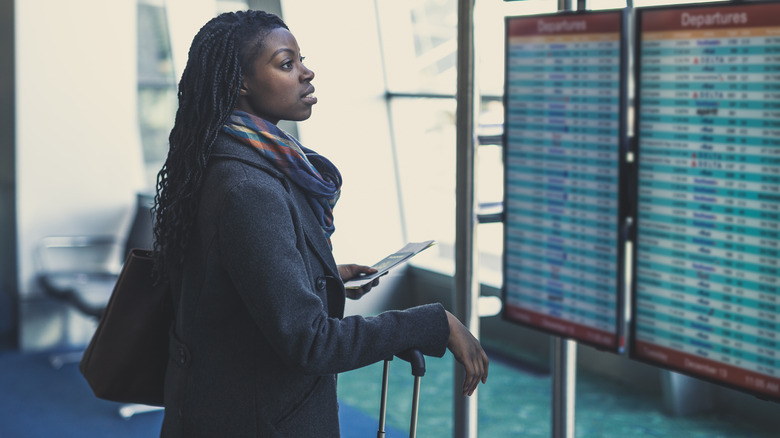 Woman looking at airport screen