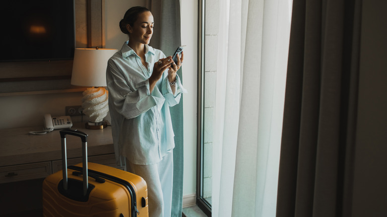 Guest with their luggage in hotel room