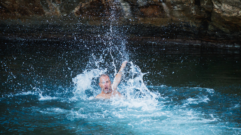 man splashing in water