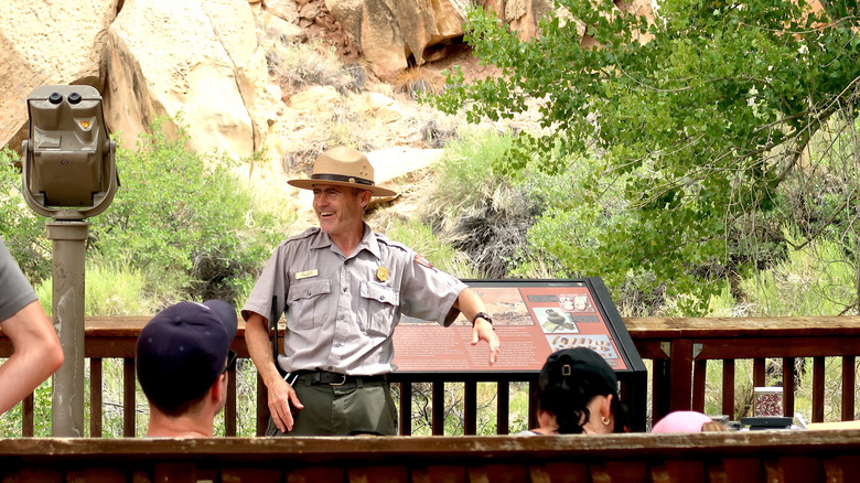 happy park ranger speaking to people
