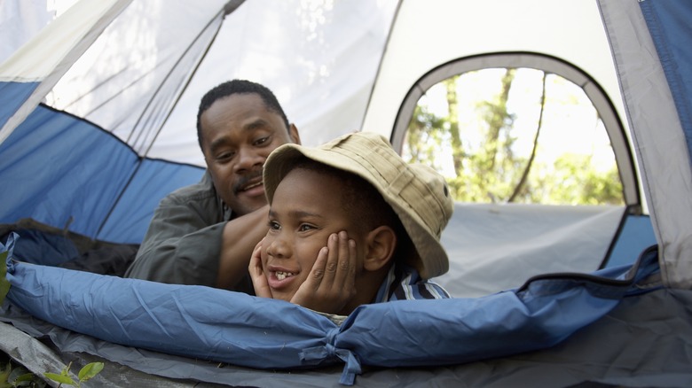father and son inside tent