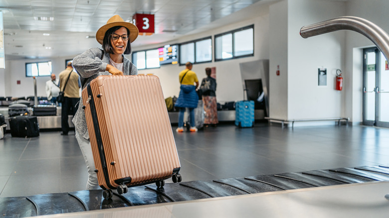 Traveler collecting their checked luggage