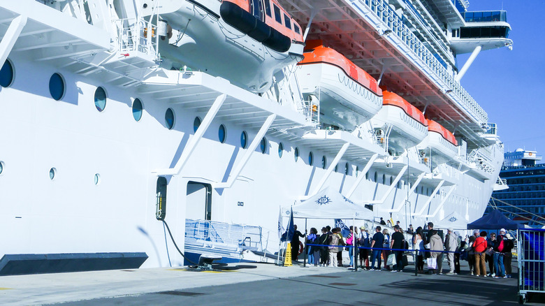 Passengers boarding large cruise ship