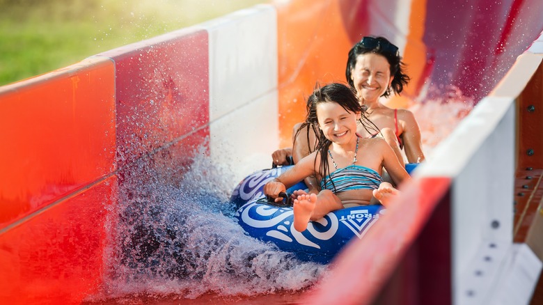 Family riding down water slide