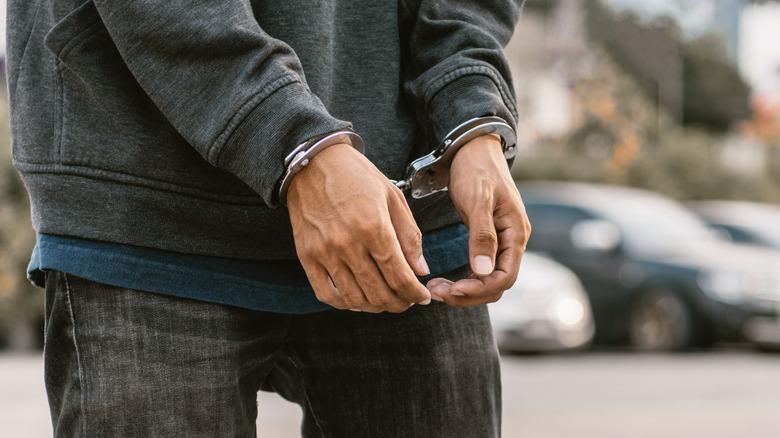 Close-up of hands in cuffs