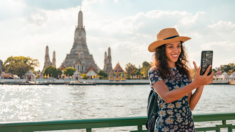 Smiling traveler taking a selfie in Thailand
