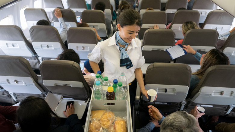 Flight attendant serving meals