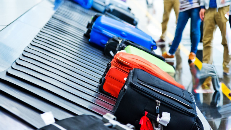 Suitcases on a baggage claim carousel