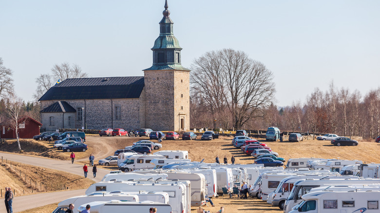 Bjurum church with motorhomes and caravans by Lake Hornborgasjön in Sweden