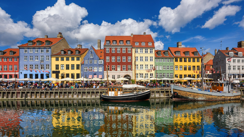 View across the water of colorful traditional houses in the Old port of Nyhavn in Copenhagen