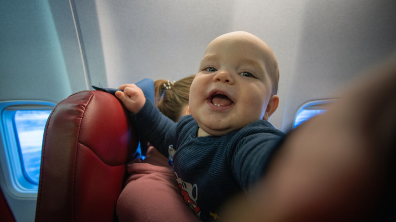 baby on plane pretending to be innocent