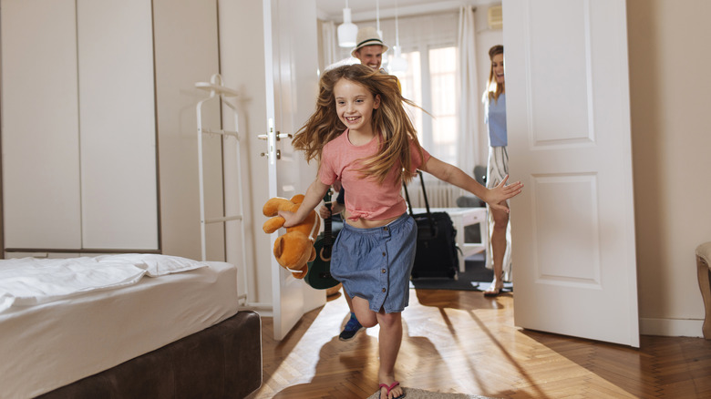 Excited girl in hotel room