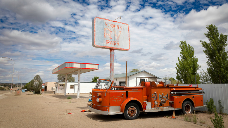 old firetruck by faded RV park sign
