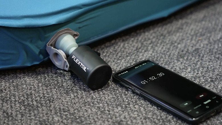 A portable air pump being used to deflate a camping mattress in less than three minutes.