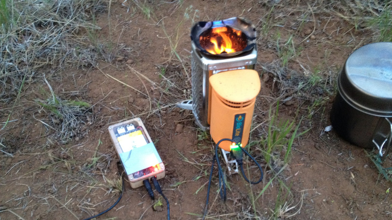 Portable stove charging a device while burning