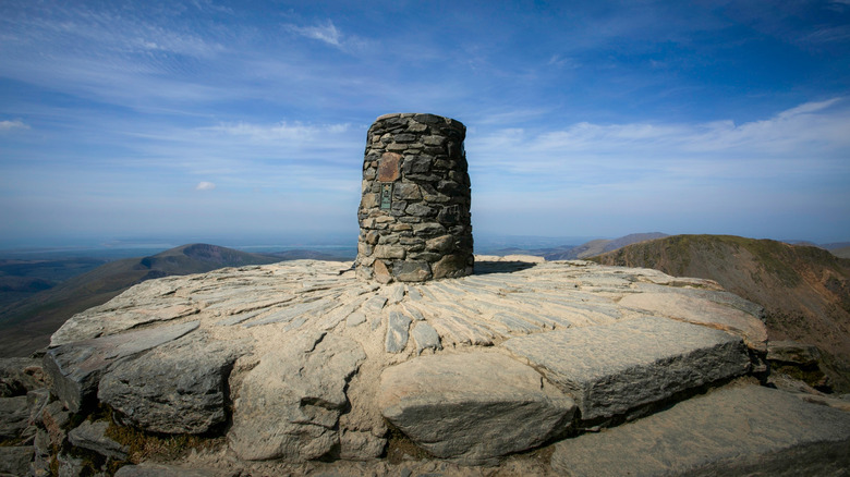 A stone marker on the summit of Mount Snowdon, Wales