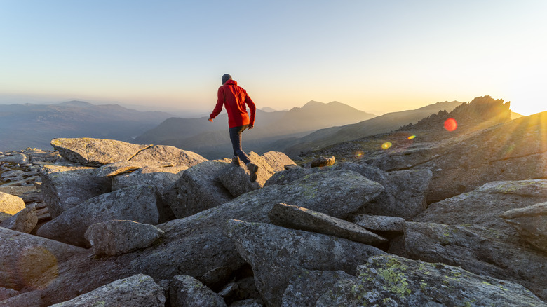 A hiker moves across an area of large stones on Snowdon mountain in Wales