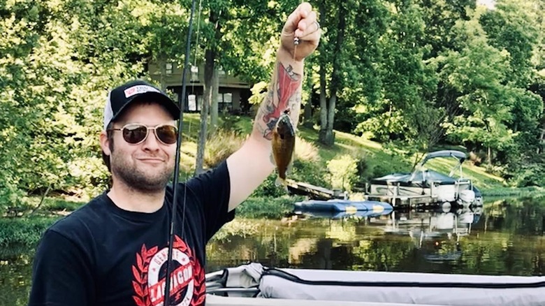 Man showing off fish catch