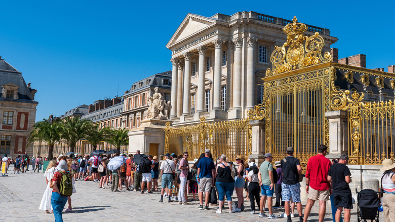 tourists waiting in line to visit palace