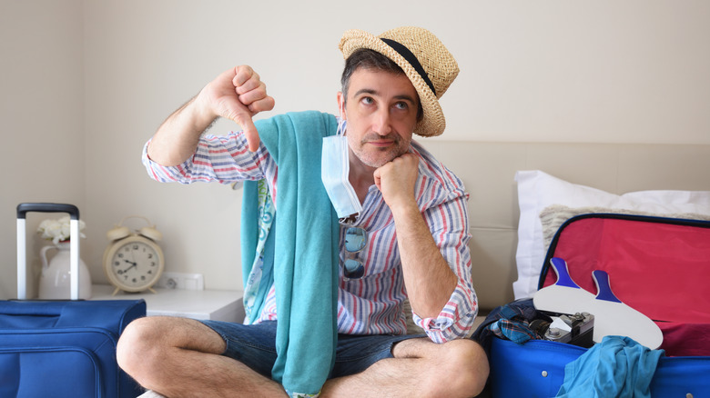 grumpy tourist on hotel bed