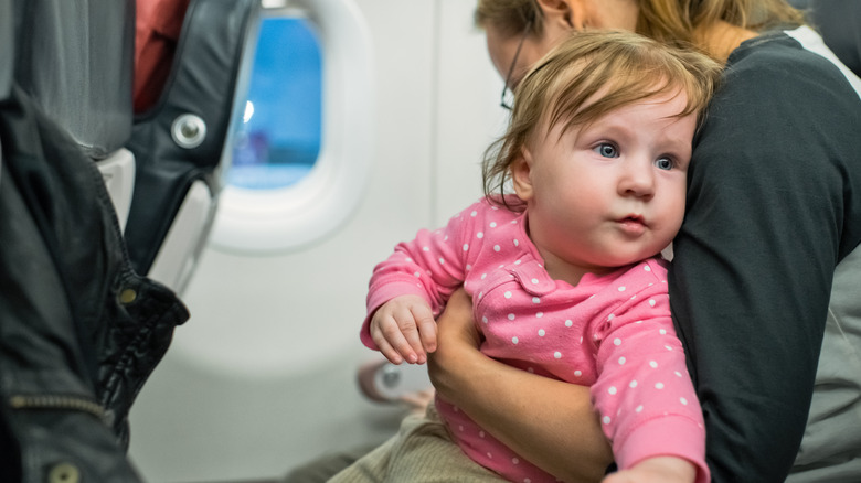 baby and woman on plane