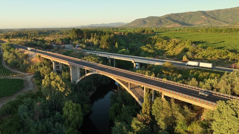 Aerial shot of Pan-American Highway road bridge crossing vineyards in Maule Valley in Chile