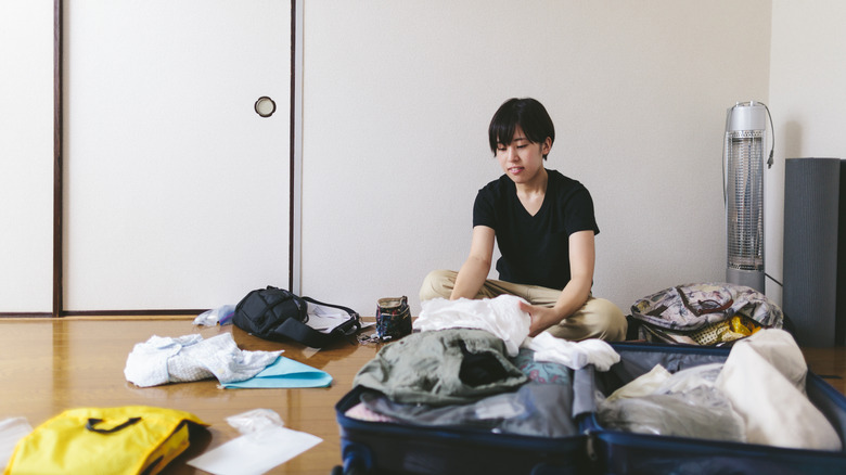 woman packing suitcase