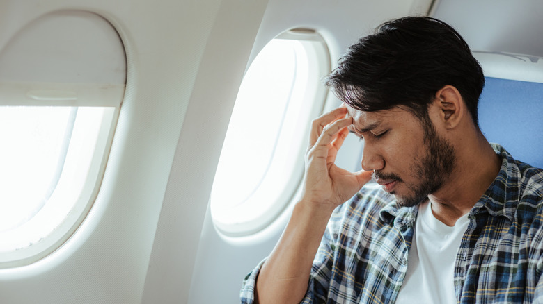 An upset person on an airplane.