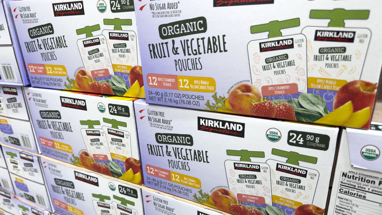 Stacked boxes of Kirkland Fruit & Veggie pouches on Costco shelves