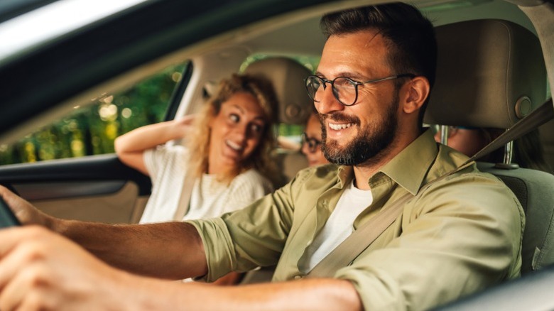 family in car on road trip