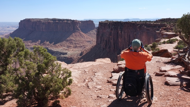 man in wheelchair on hiking trail