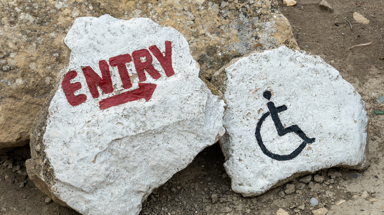 entry and wheelchair signs on rocks