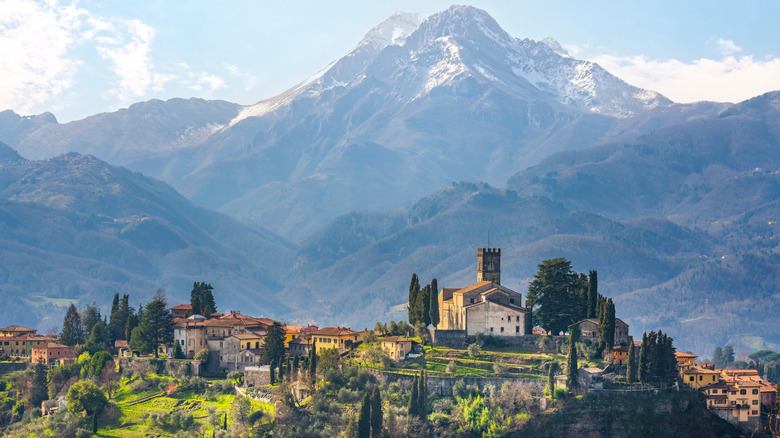 Barga town and Alpi Apuane mountains in winter in the background.
