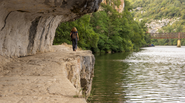A woman walks on the Chemin de Halage
