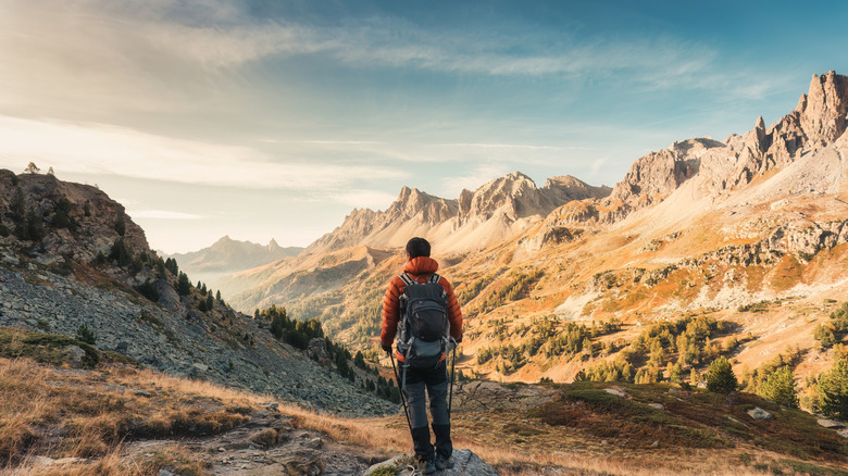 male hiker hiking with enjoying the French Alps scenery