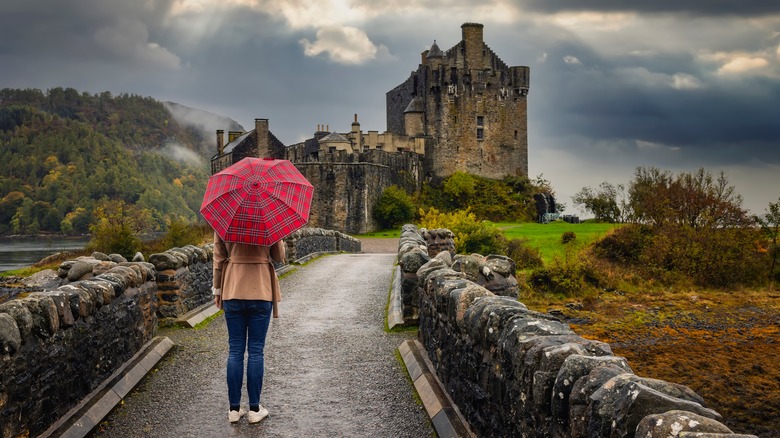 girl with red umbrella and castle